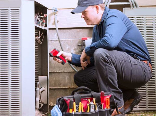 Man doing maintenance on an air conditioner